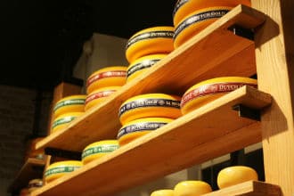 This picture shows storage shelves supported by angle irons. The shelves hold cheese. Small image.