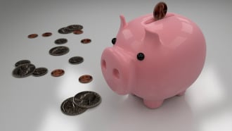 This image shows a piggy bank with coins. It symbolizes "saving money".