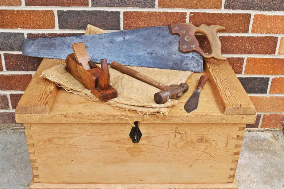 This shows several tools on a wooden box.
