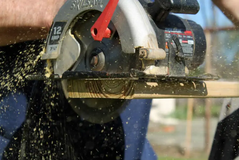 This image shows a circular saw cutting through wood. It is from the What Is The Average Weight Of A Circular Saw blog post. Large image.