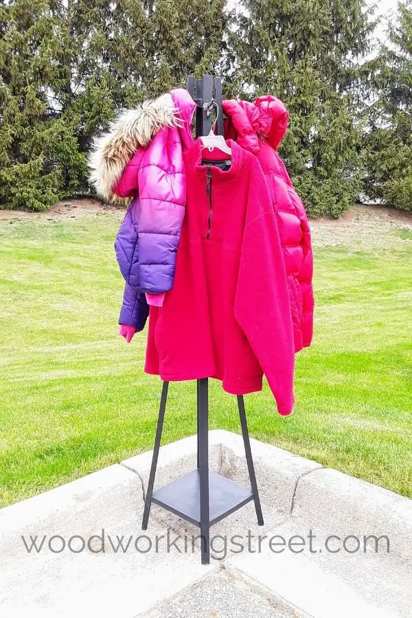 freestanding coat rack outside with green grass