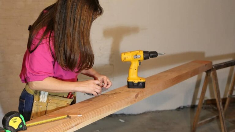 Woman with drill and measuring tape