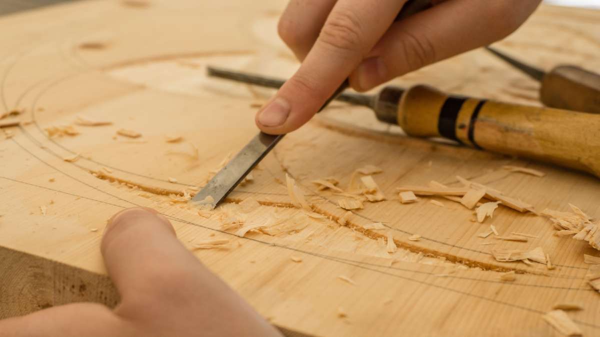 Hands with woodworking tools - 11 Benefits Of Woodworking As A Hobby
