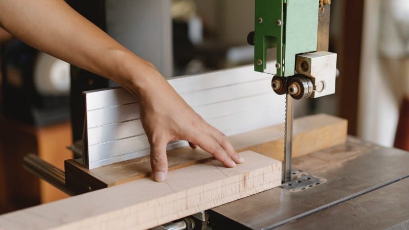 Man using a bandsaw - Do I Need To Use A Jigsaw To Cut Curves