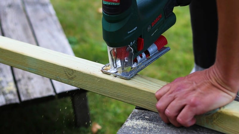 Green jigsaw cutting wood