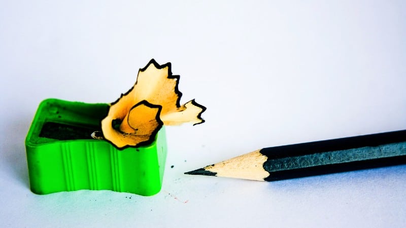 Green pencil sharpener and colored pencil