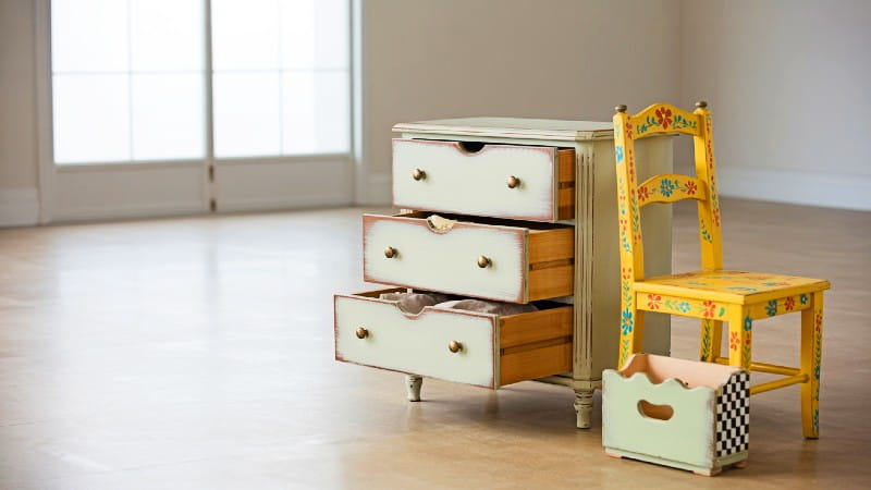 Collection of stunning hand-painted furniture pieces including a vintage dresser and colorful chair, showcasing ideas to elevate home décor.