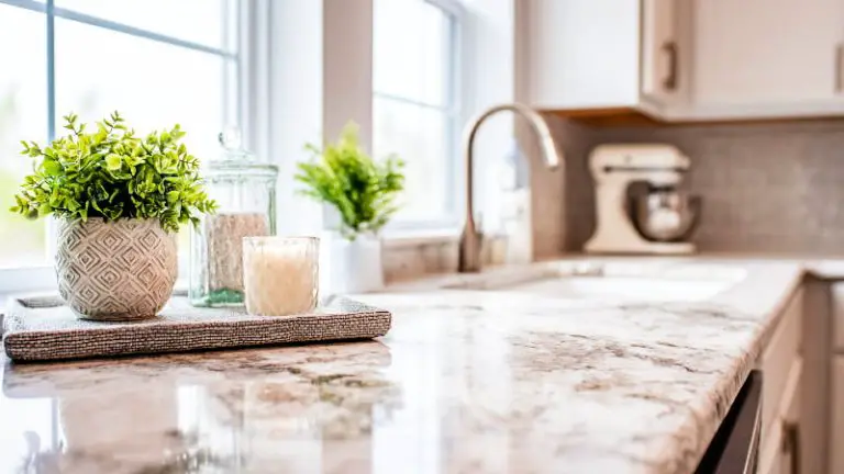 A modern kitchen countertop beautifully styled with minimalist decor and essential appliances, bathed in natural light.