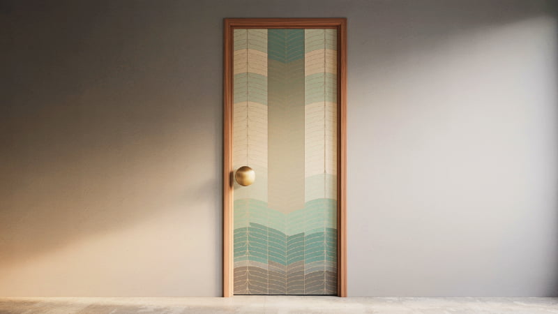 A stylish modern door with a geometric pattern mural and a distinctive oversized doorknob.