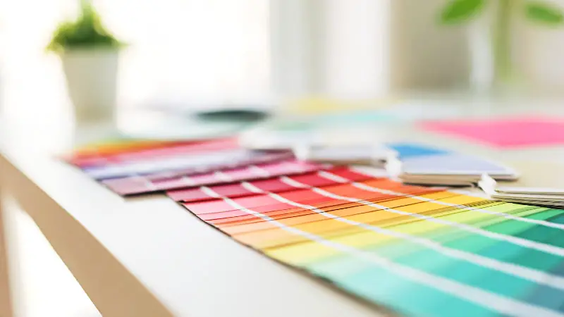 A close-up image of neatly arranged color swatches on a clean desk, highlighting color variations in a minimalist setting.